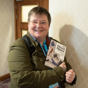 Agi Gault holding her book at the launch event