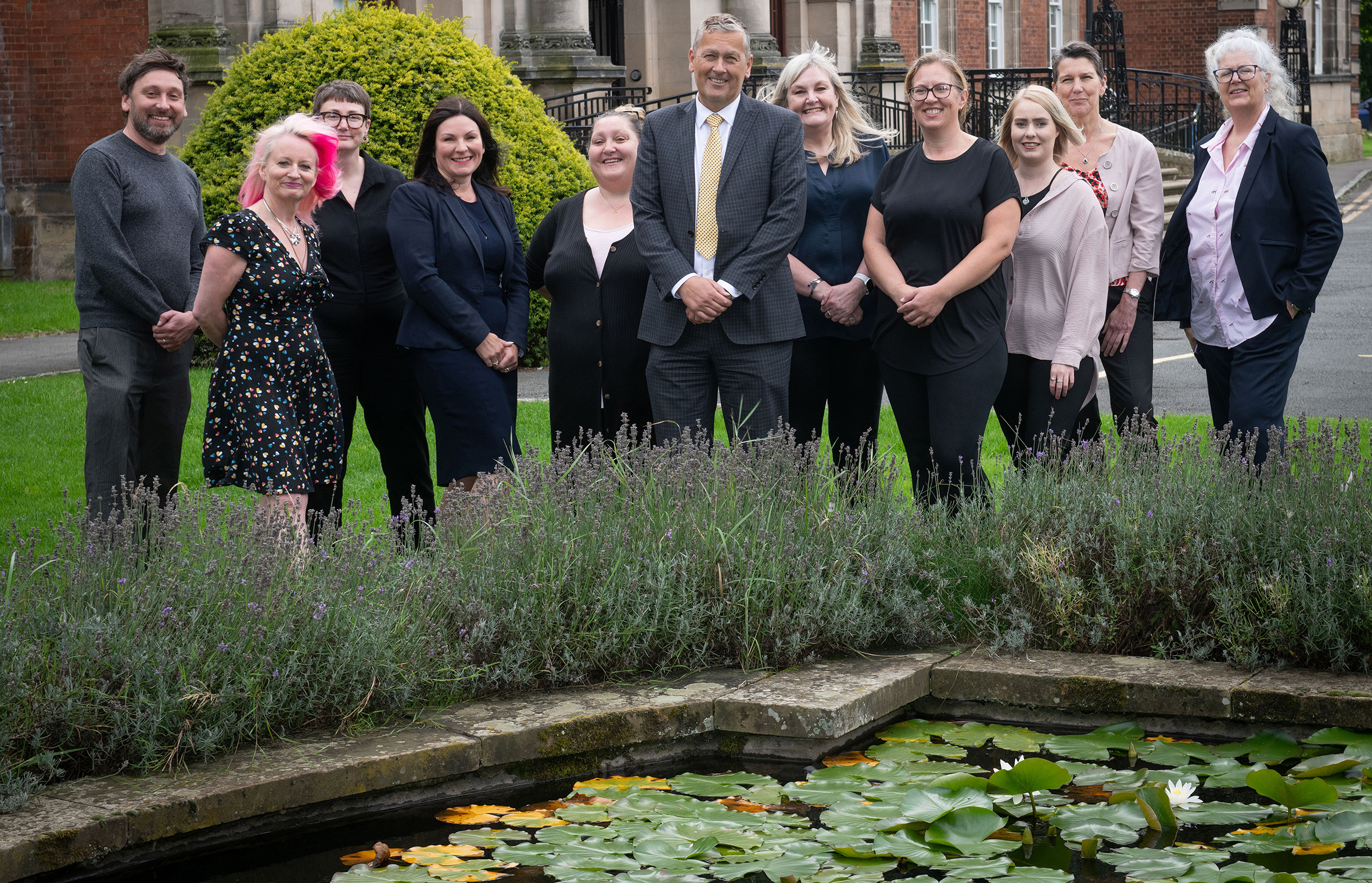 The team of North Yorkshire Council standing in front of a pond