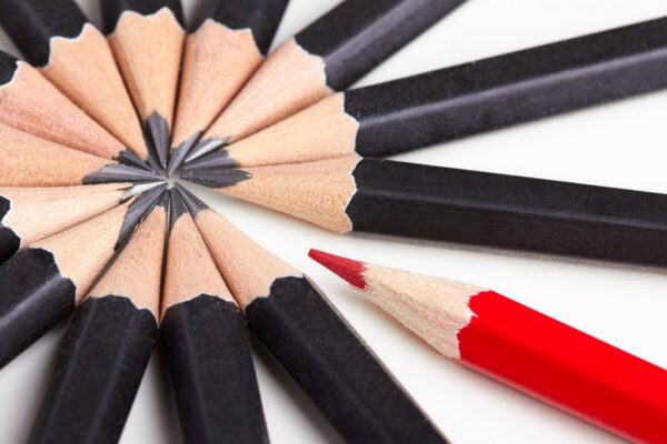 North Lincolnshire Council achieves outstanding from Ofsted. Image shows a circle of black pencils and one red pencil