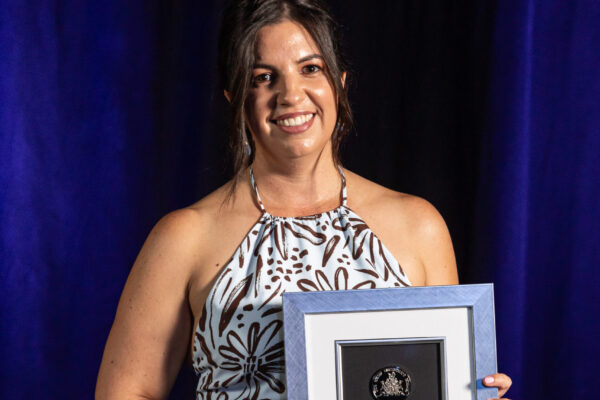 Sarah Codrington holding her award